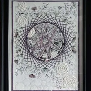 Framed string art with floral details.