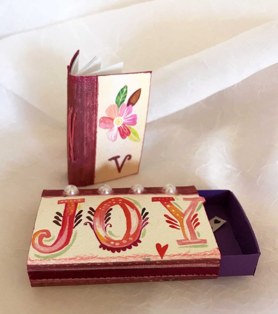 Handpainted matchbox with "Joy" design.