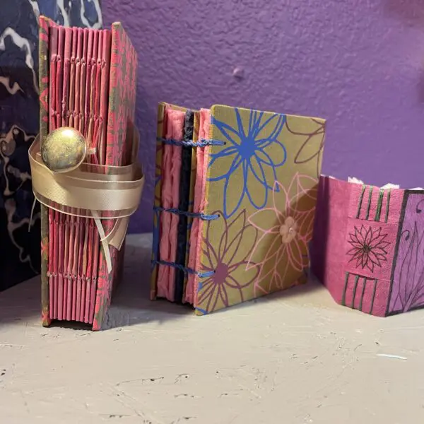 Colorful handmade journals with decorative bindings.