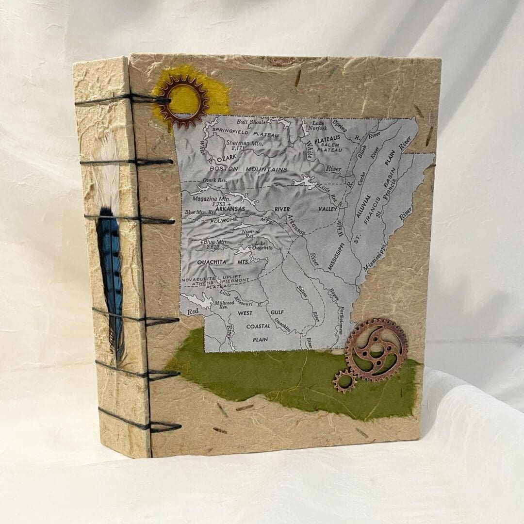 Handmade journal with Arkansas map and gears.