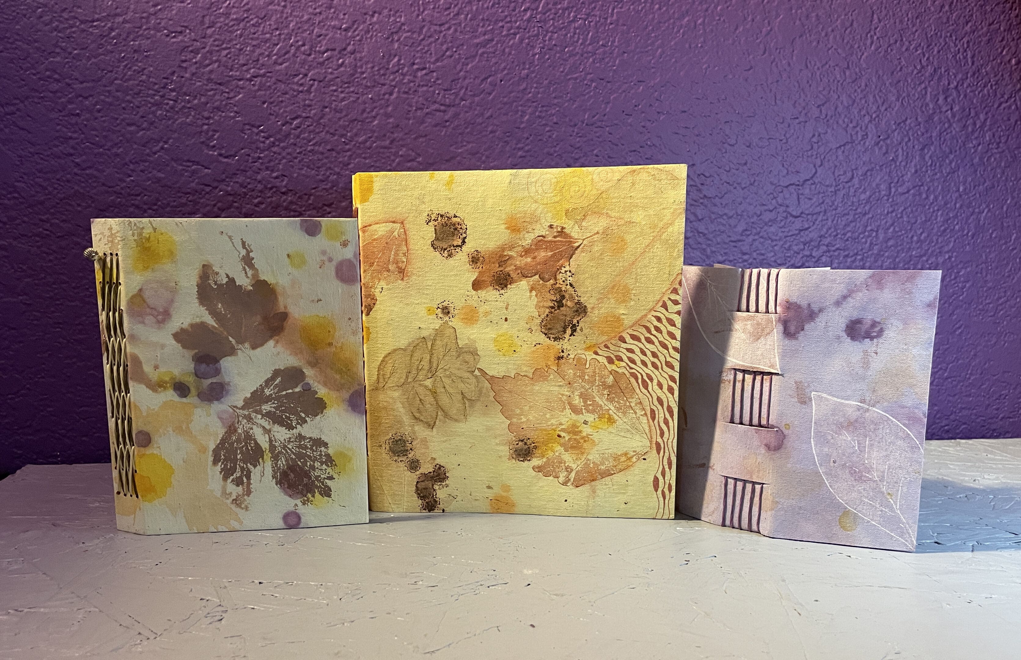 Three different designs of tiles on a table.