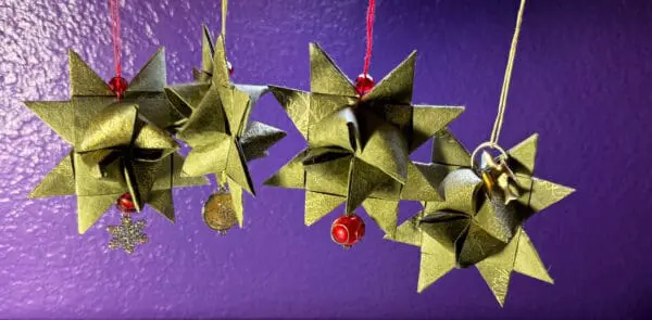 A close up of some origami stars hanging from strings