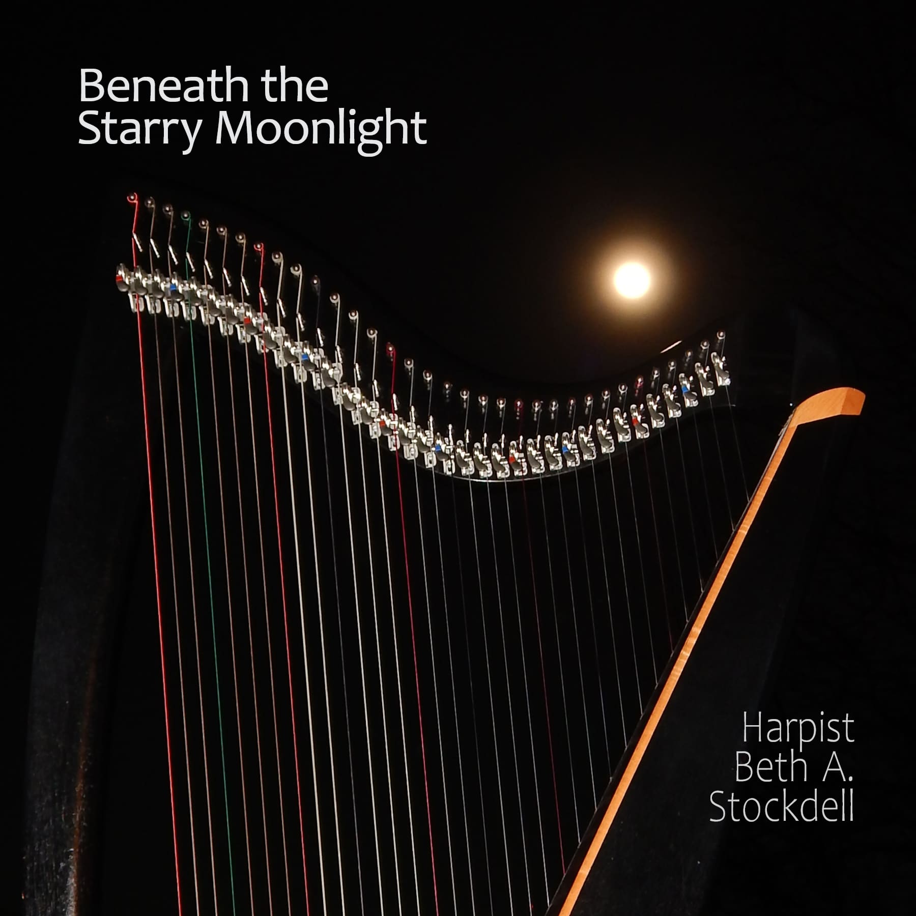 A harp is shown in front of the moon.