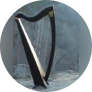 A harp is shown in front of a stone wall.