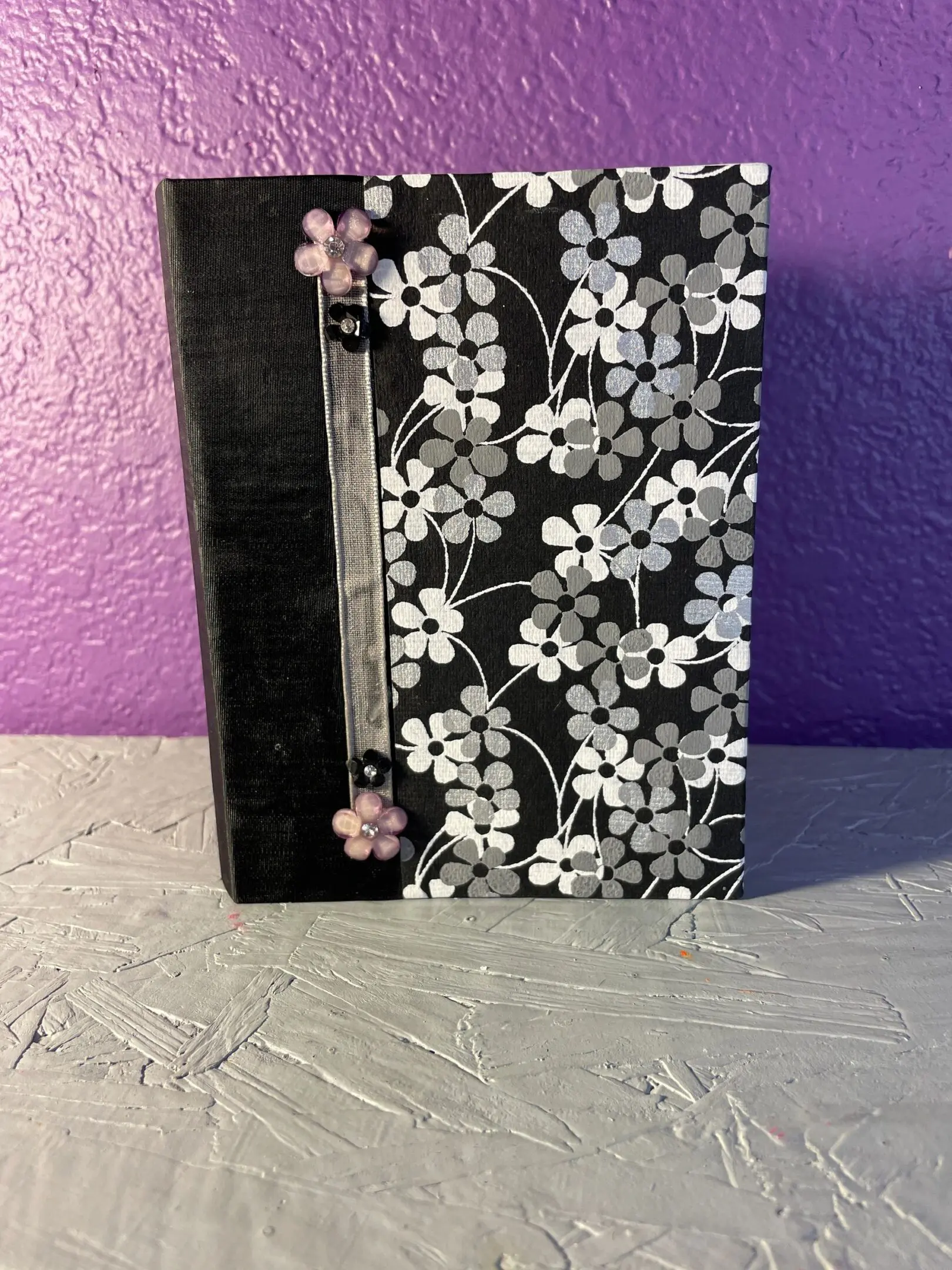 A black and white book with flowers on it