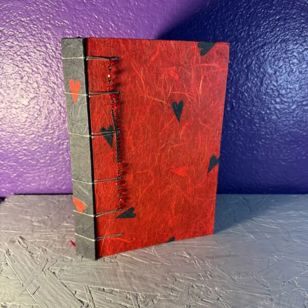 A red book with green leaves on the cover.