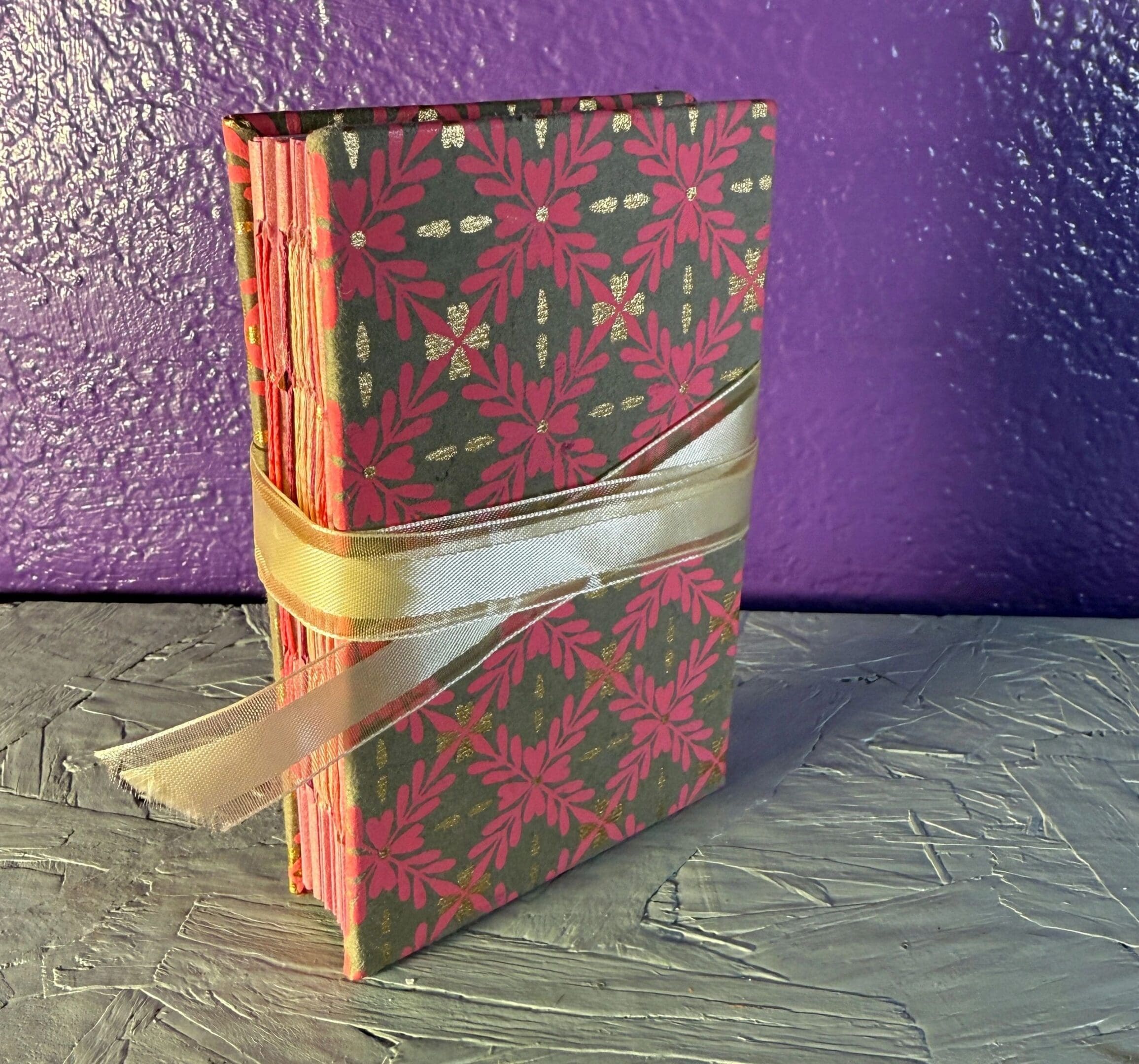 A book with a ribbon wrapped around it.